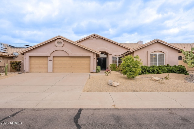 mediterranean / spanish house featuring a tile roof, an attached garage, driveway, and stucco siding