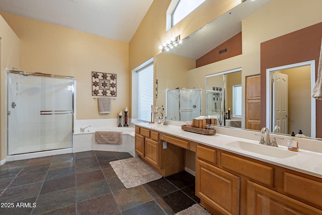 full bathroom featuring a shower stall, a garden tub, double vanity, high vaulted ceiling, and a sink