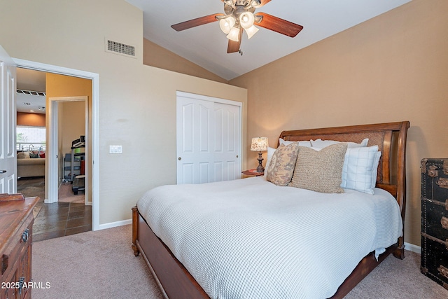 bedroom featuring visible vents, baseboards, vaulted ceiling, carpet flooring, and a closet