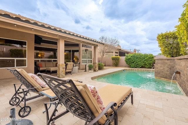 pool with an outdoor living space, a patio, and a fenced backyard