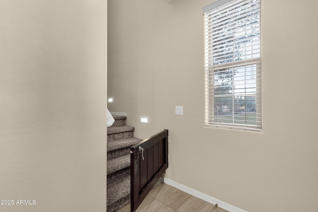 bathroom with baseboards and tile patterned floors