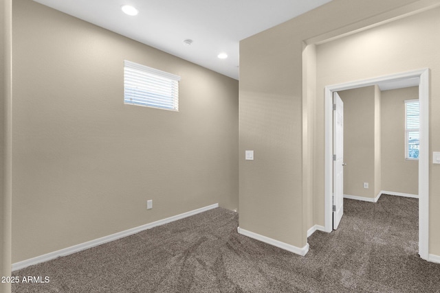 below grade area featuring carpet floors, baseboards, and recessed lighting