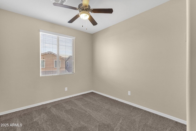 spare room featuring a ceiling fan, dark carpet, and baseboards