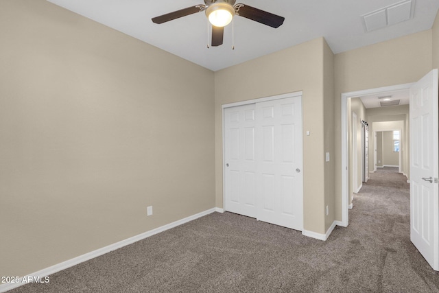 unfurnished bedroom with carpet flooring, visible vents, and baseboards