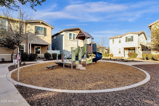 view of jungle gym featuring a residential view and fence