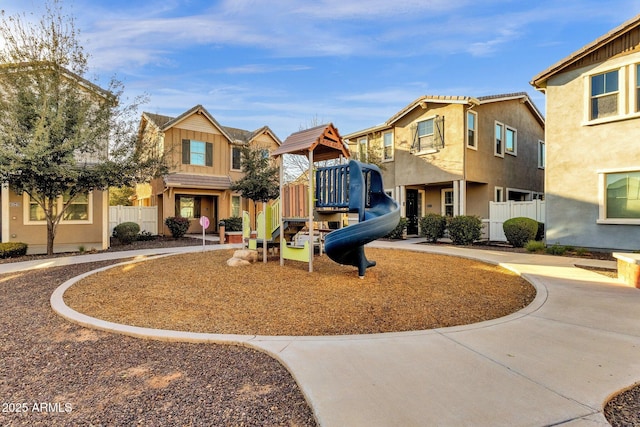 exterior space with a residential view, playground community, and fence