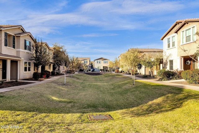 view of home's community featuring a residential view and a yard