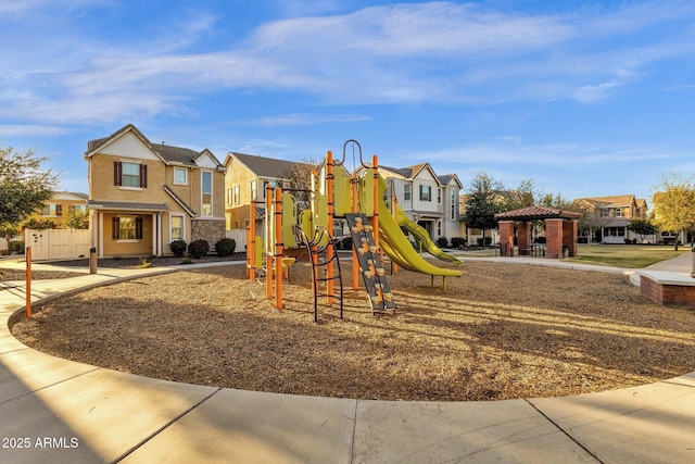 community playground featuring a gazebo and a residential view