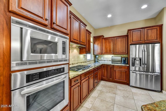 12903 W Brookhart Way, Peoria, AZ 85383 - kitchen featuring stainless steel appliances, backsplash, light stone counters, light tile patterned floors, and recessed lighting