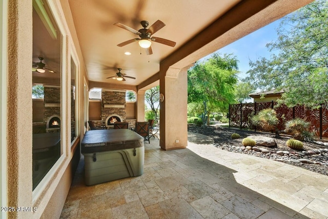 12903 W Brookhart Way, Peoria, AZ 85383 - view of patio / terrace with an outdoor stone fireplace and a ceiling fan