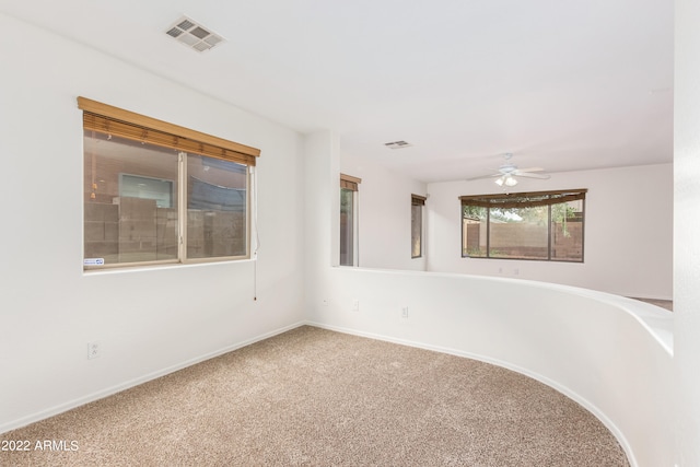 unfurnished room featuring ceiling fan and carpet floors