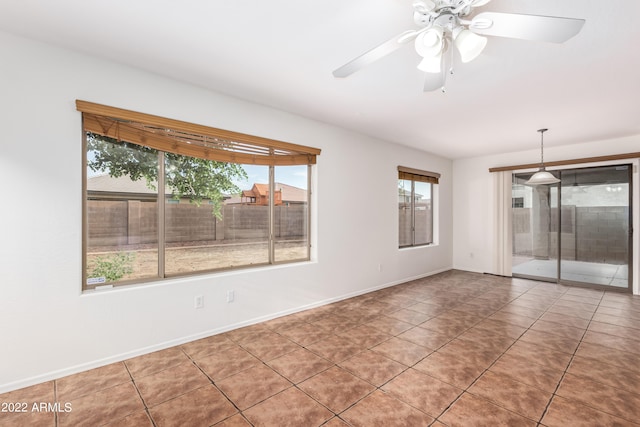 empty room featuring ceiling fan and tile patterned floors