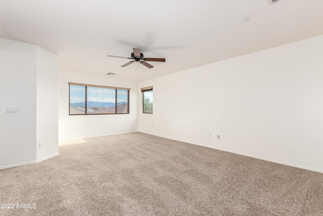 spare room with carpet flooring and ceiling fan