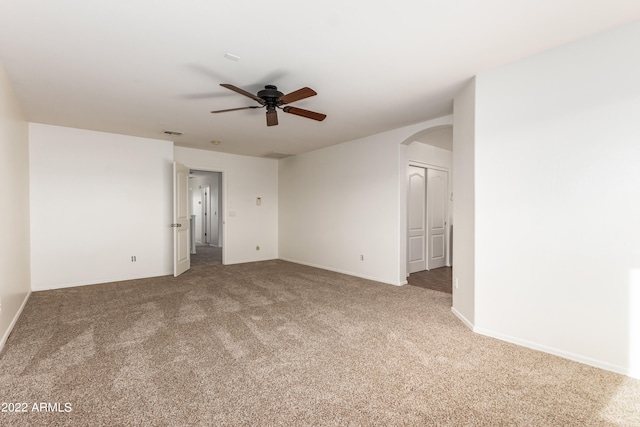 spare room featuring ceiling fan and carpet