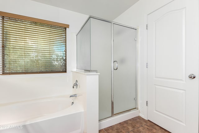 bathroom featuring tile patterned flooring and separate shower and tub