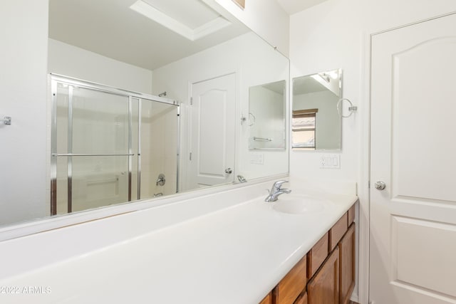 bathroom featuring vanity and a shower with shower door