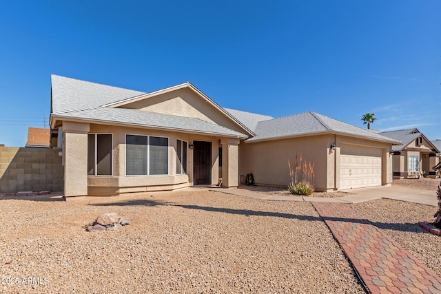 ranch-style house with a garage, concrete driveway, roof with shingles, and stucco siding