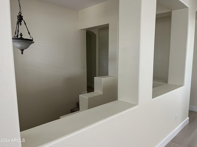 hallway with hardwood / wood-style floors