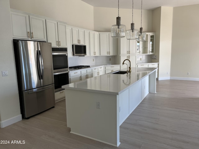 kitchen featuring light hardwood / wood-style floors, sink, stainless steel appliances, and white cabinetry