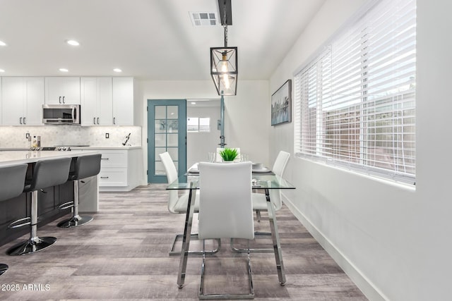 8522 E Virginia Ave, Scottsdale, AZ 85257 - dining space with light wood finished floors, recessed lighting, and baseboards