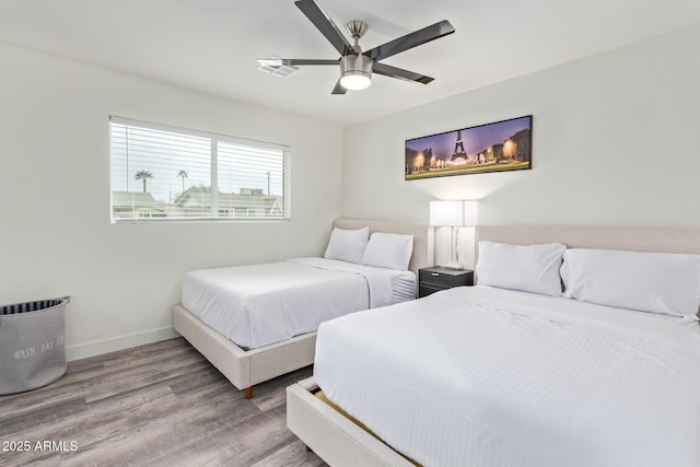 8522 E Virginia Ave, Scottsdale, AZ 85257 - bedroom with wood finished floors, baseboards, and a ceiling fan