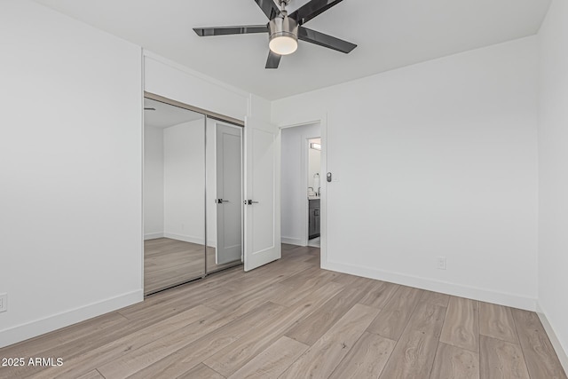 8522 E Virginia Ave, Scottsdale, AZ 85257 - unfurnished bedroom featuring light wood finished floors, baseboards, a closet, and a ceiling fan