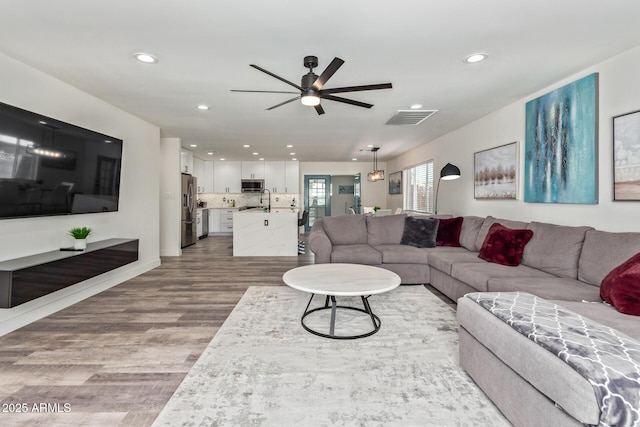 8522 E Virginia Ave, Scottsdale, AZ 85257 - living area with wood finished floors, ceiling fan, and recessed lighting