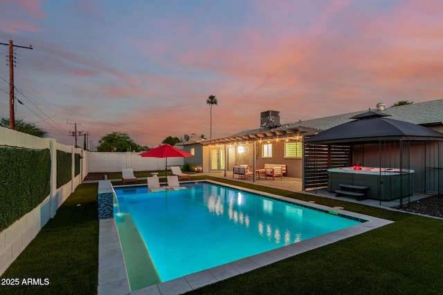 8522 E Virginia Ave, Scottsdale, AZ 85257 - pool at dusk featuring a hot tub, a gazebo, a patio area, and an outdoor hangout area