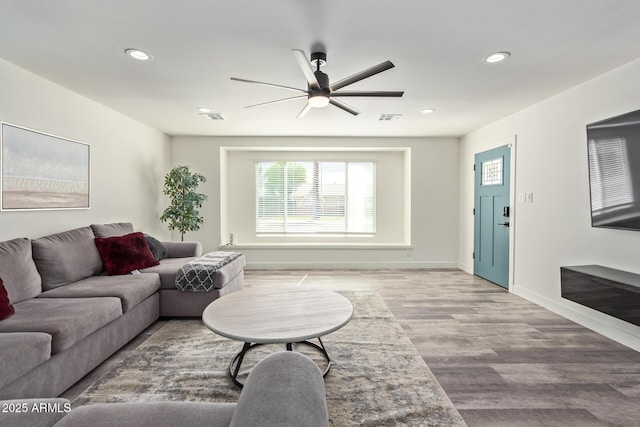 8522 E Virginia Ave, Scottsdale, AZ 85257 - living area featuring healthy amount of natural light, ceiling fan, recessed lighting, light wood finished floors, and baseboards