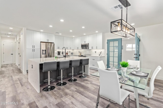 8522 E Virginia Ave, Scottsdale, AZ 85257 - dining space featuring light wood-type flooring and recessed lighting