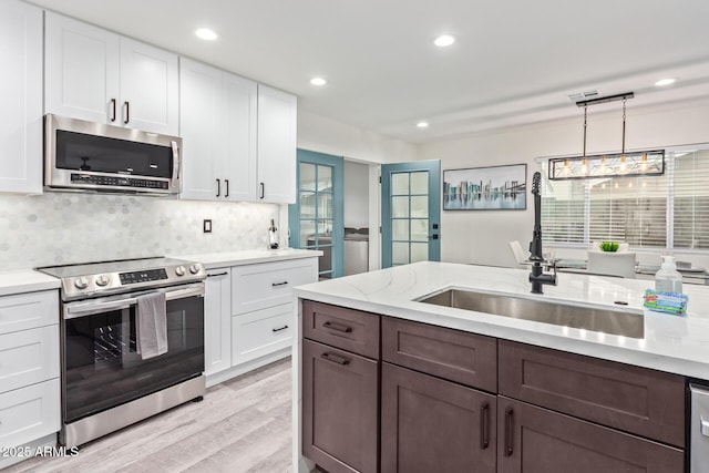 8522 E Virginia Ave, Scottsdale, AZ 85257 - kitchen featuring appliances with stainless steel finishes, white cabinetry, a sink, tasteful backsplash, and recessed lighting