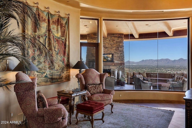 sitting room with a mountain view and a fireplace