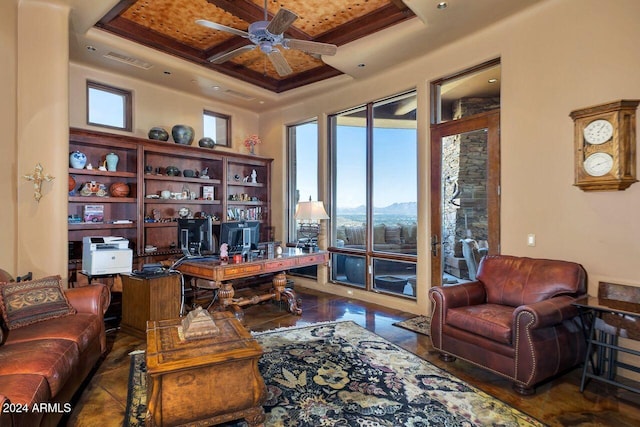 office featuring ceiling fan, coffered ceiling, beamed ceiling, a mountain view, and a tray ceiling