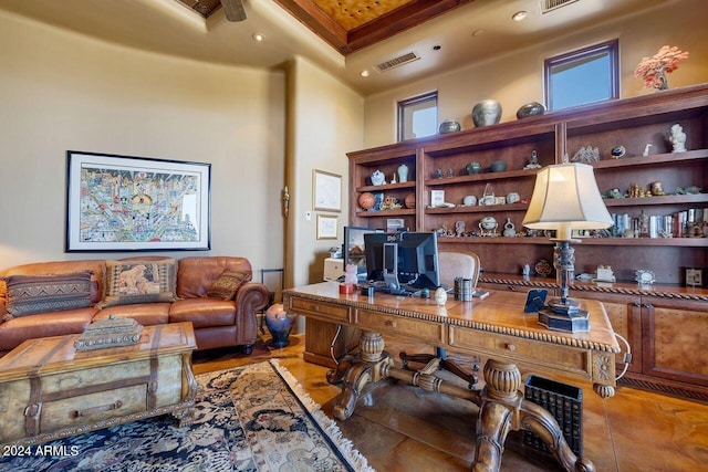 office area featuring ceiling fan, a towering ceiling, and ornamental molding