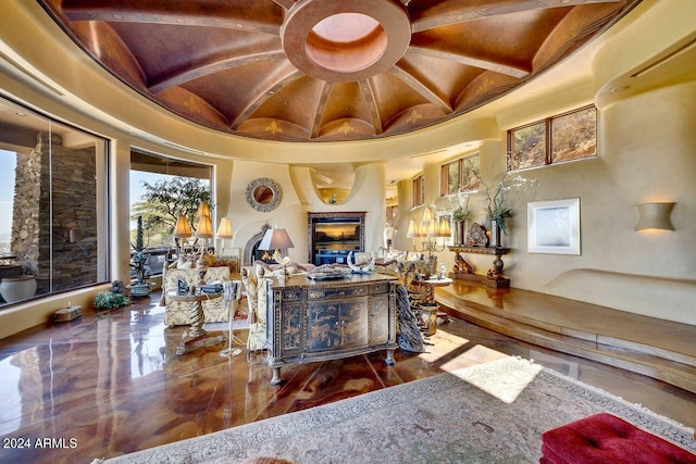 living room featuring beamed ceiling and a high ceiling