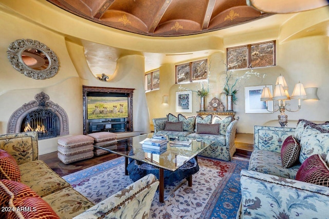 living room featuring beamed ceiling and hardwood / wood-style floors