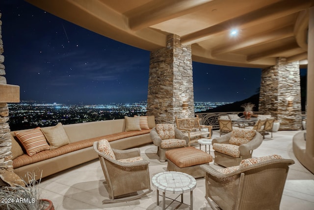 home theater room featuring beam ceiling and ornate columns