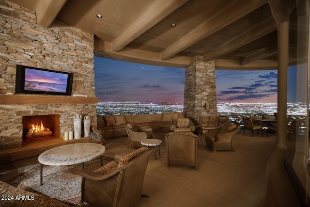 patio terrace at dusk with an outdoor stone fireplace