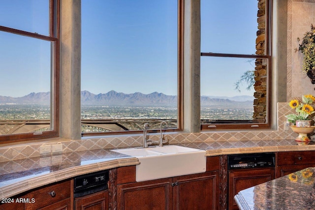 kitchen featuring a mountain view, plenty of natural light, and sink