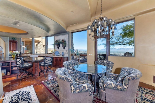 dining area with dark tile patterned floors and a chandelier