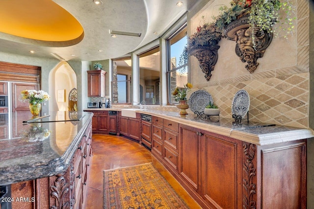 interior space with decorative backsplash, sink, and black appliances