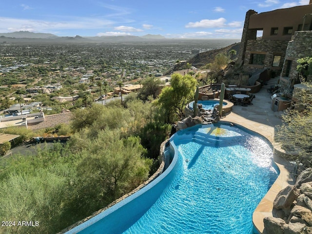 view of swimming pool with a mountain view