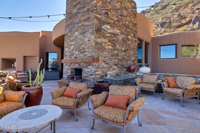 view of patio with an outdoor stone fireplace