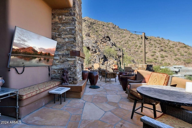 view of patio featuring a mountain view and an outdoor hangout area