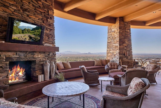 view of patio / terrace featuring a mountain view and an outdoor living space with a fireplace