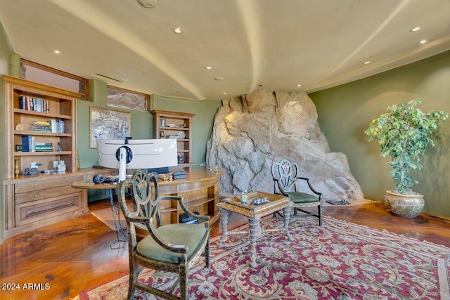 living area featuring hardwood / wood-style floors and built in desk