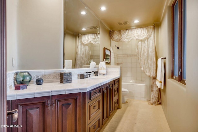 full bathroom featuring toilet, vanity, and tiled shower / bath