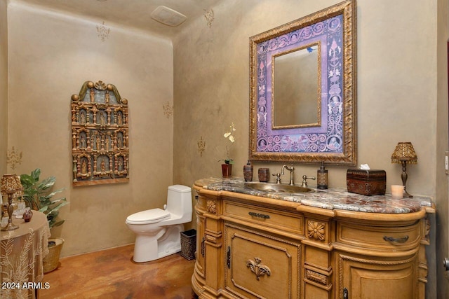 bathroom with vanity, concrete floors, and toilet