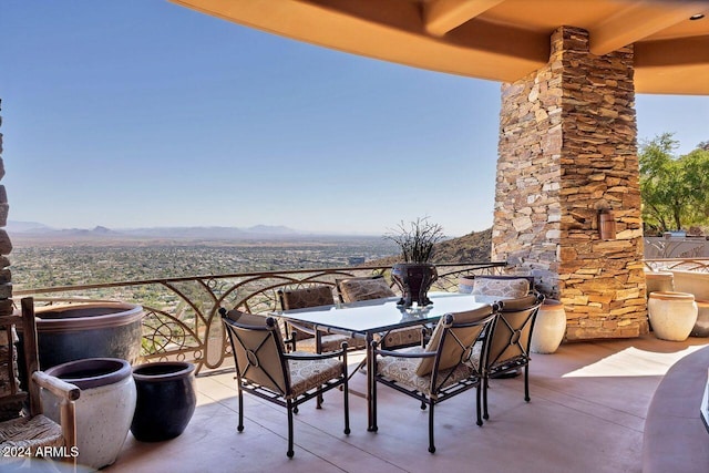 view of patio / terrace with a mountain view and a balcony