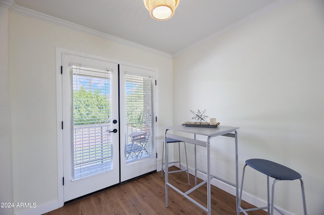 doorway with hardwood / wood-style floors, ornamental molding, and french doors